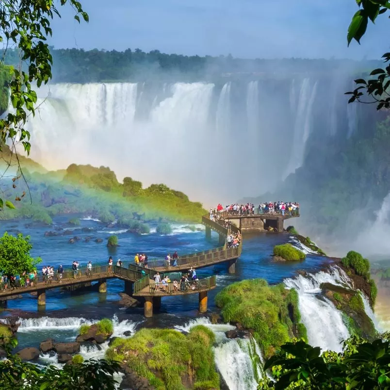 Puerto Iguazu Falls with tourists on a boardwalk overlooking the falls