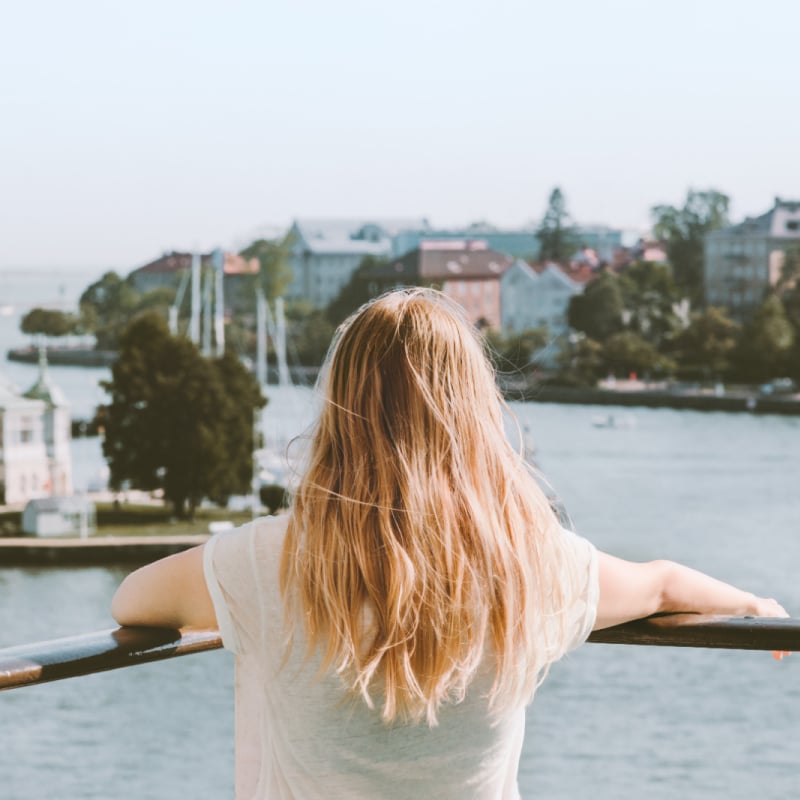 Woman looking out over town in finland