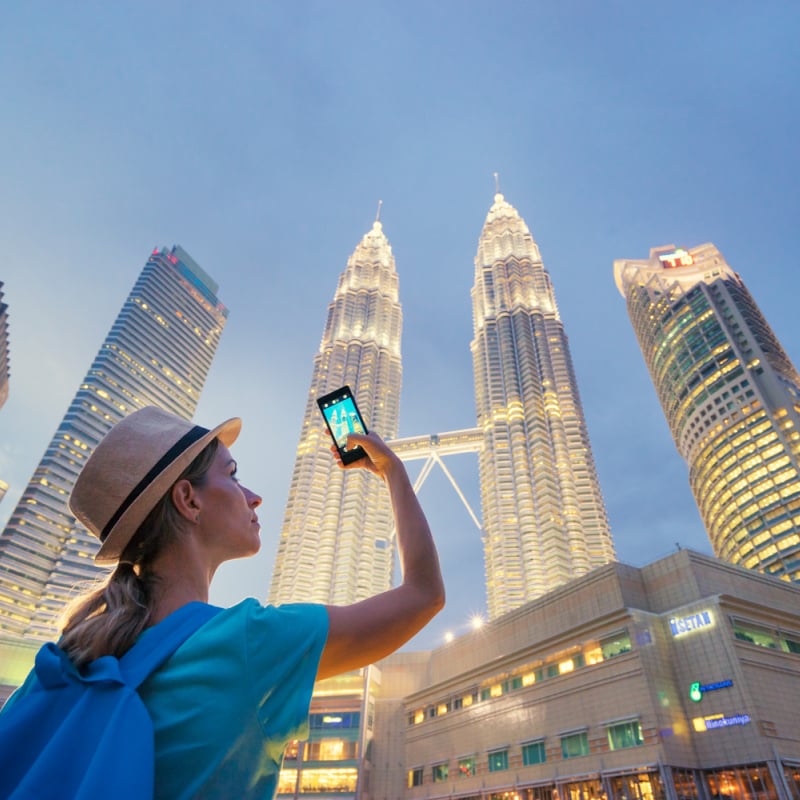 tourist taking picture of Kuala Lumpur skyline