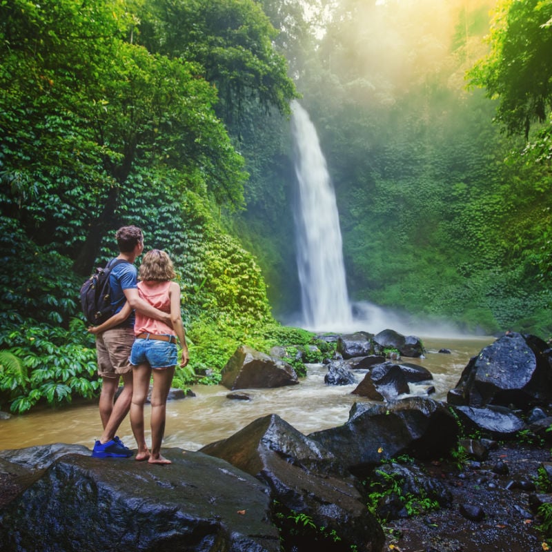 travelers visiting waterfall in Malaysia