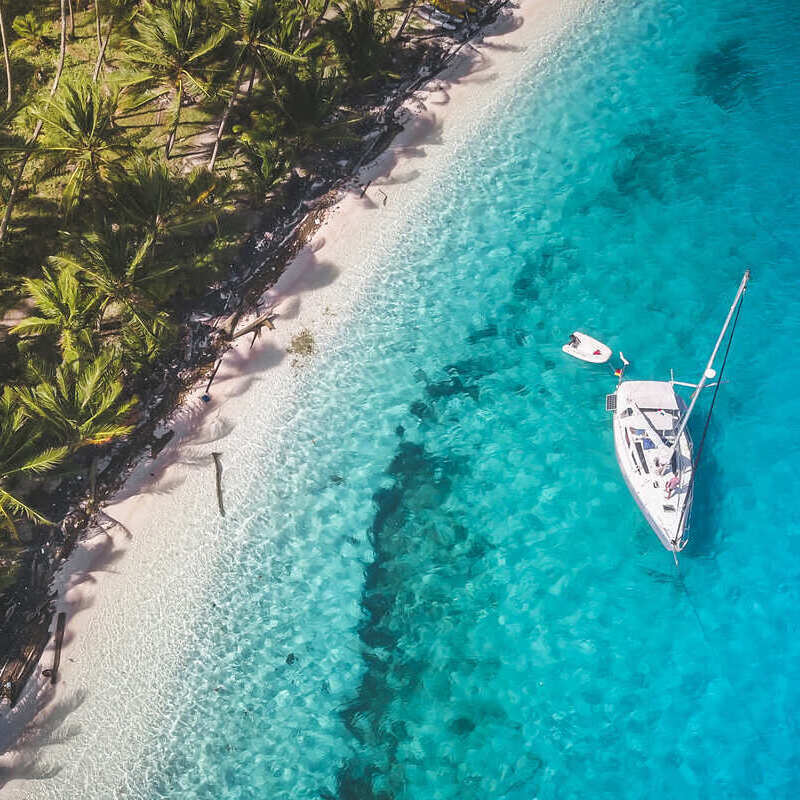 Aerial View Of A White Yacht Sailing Off The Coast Of San Blas, Panama, Central America