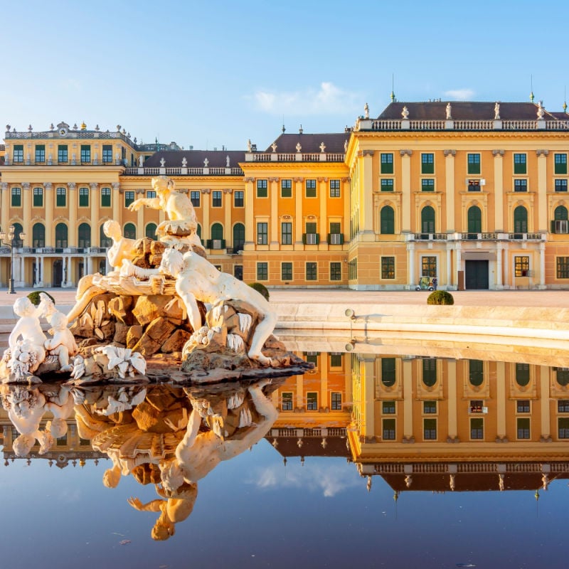 The Schonbrunn Palace in Vienna reflects in the water