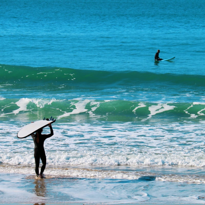 Surfers on the beach at el palmar spain