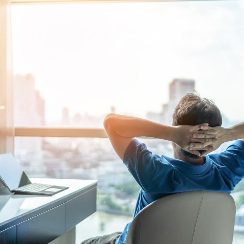 male digital nomad looking at city skyline