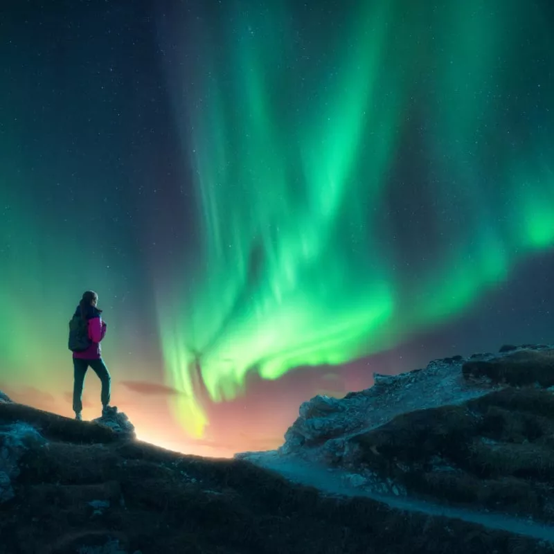 woman with northern lights in the background (