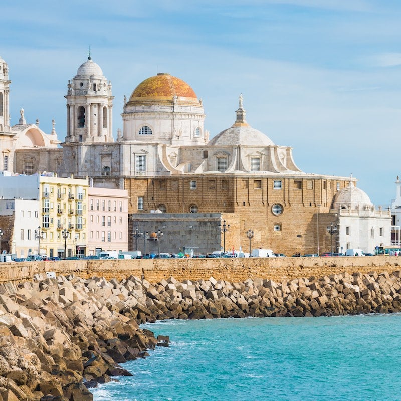 Cathedral of Cadiz in Spain view from the ocean with beautiful embankment on a sunny day with selective focus