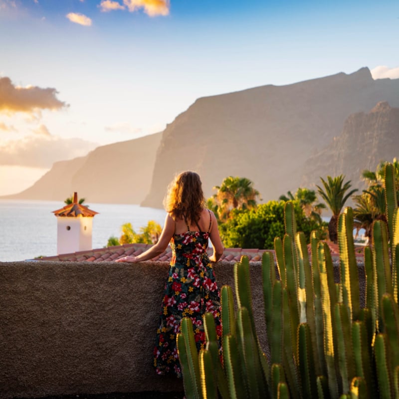 woman looking at sunset over the ocean in Tenerife Canary islands copy