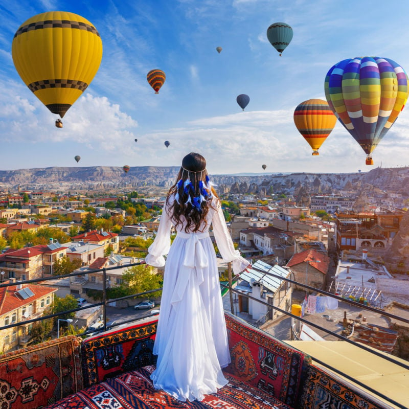 woman on a balkony overlooking Cappadocia, Turkey