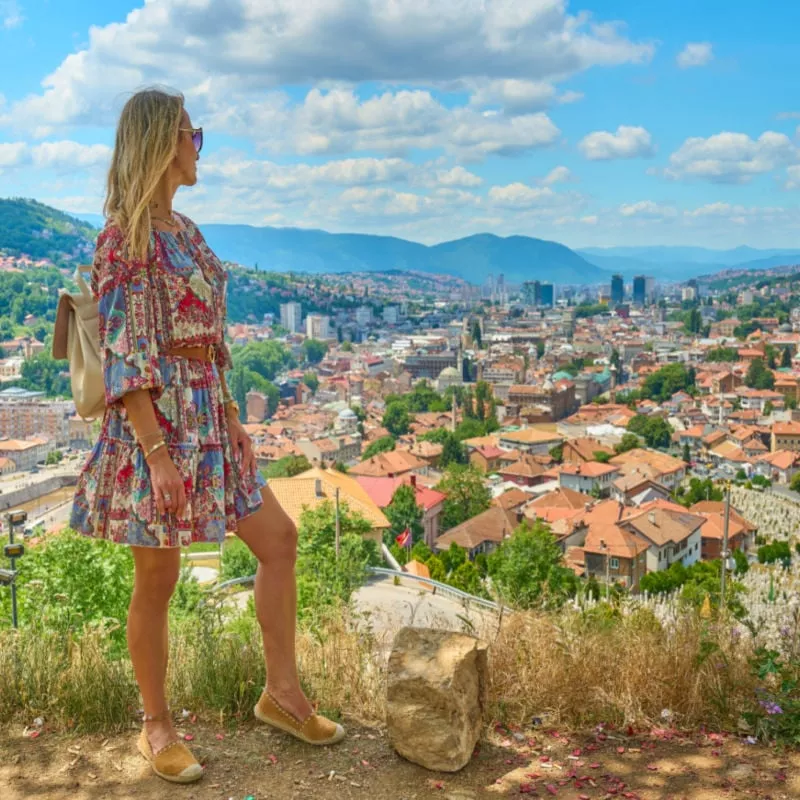 woman watching Sarajevo skyline from Yellow Bastion viewpoint 