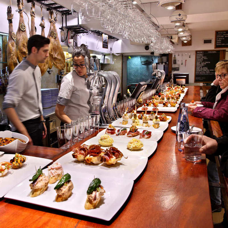 Customers Being Served In A Pintxo Bar In Donostia, San Sebastian, Spain