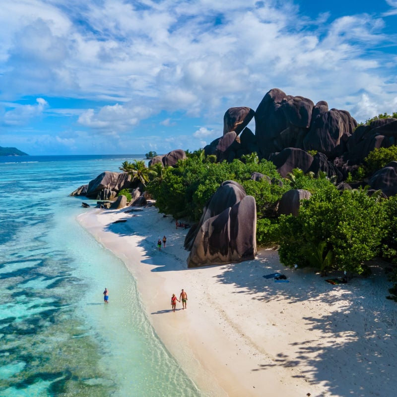 couple walking on a beach in Seychelles