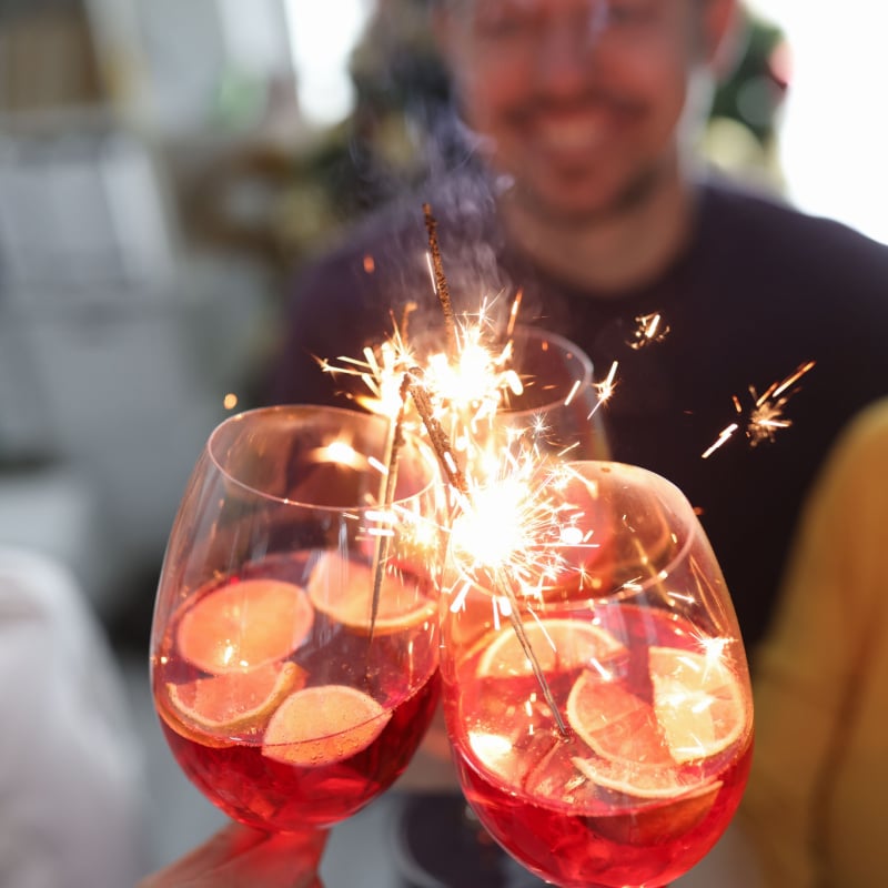 Group of people holding glasses with sparklers Cancun