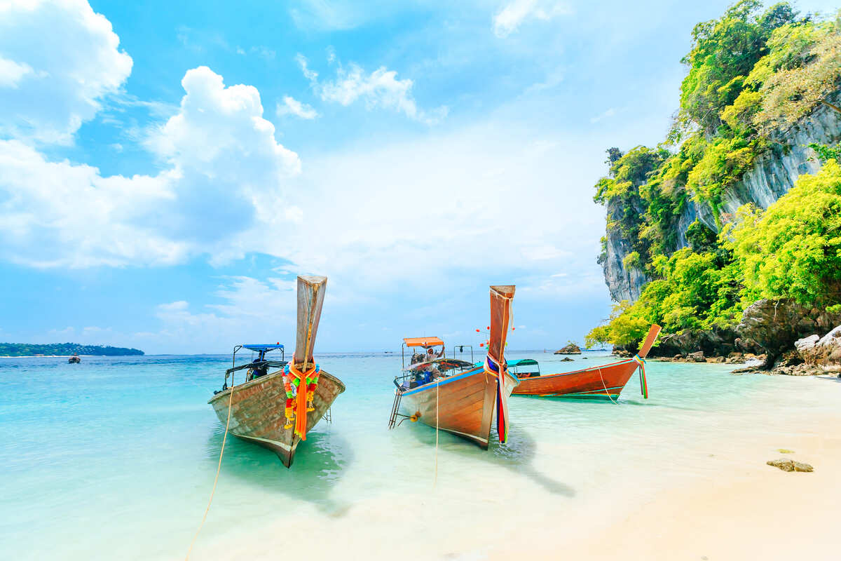 Long Tail Boats Docked On A Golden Sand Beach In Phuket, A Tropical Island In Thailand, Southeast Asia