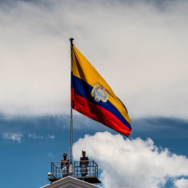 Two Ecuadorian Guards Stood Atop A Watchtower Where The Ecuadorian Flag Is Flying, Ecuador, South America