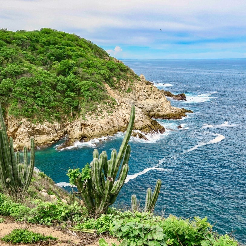 the foothills of the Sierra Madre del Sur mountains meet the Pacific Ocean.