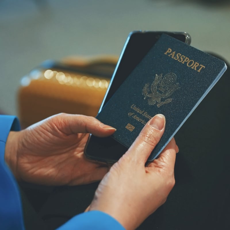 woman holding us passport waiting for a flight