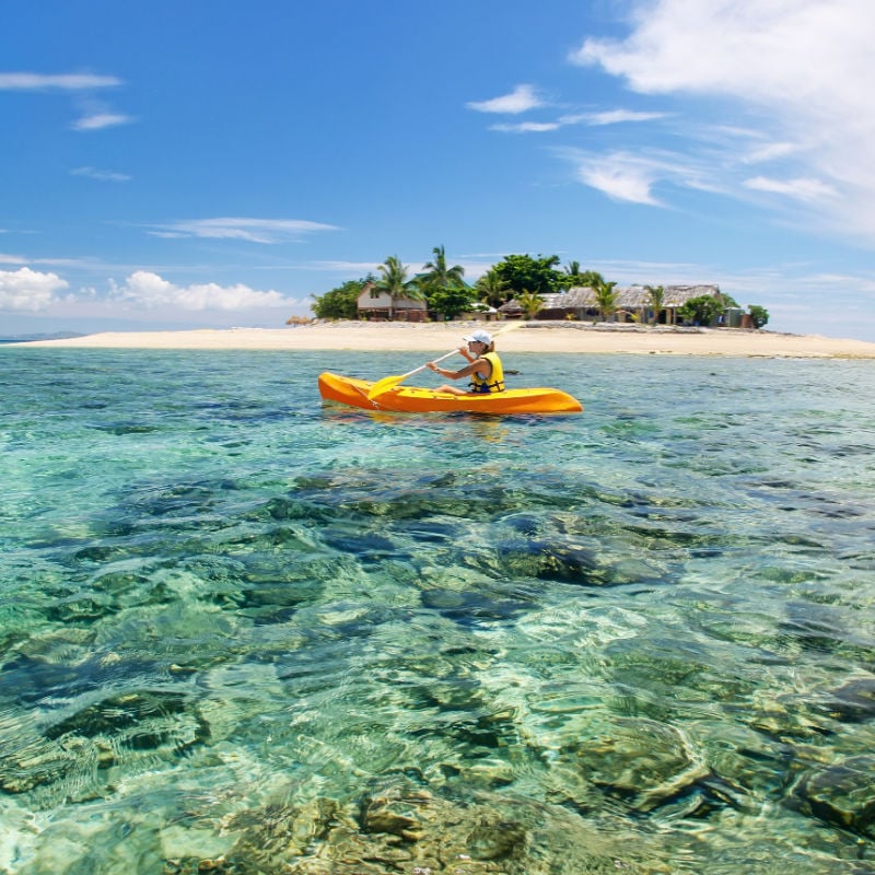 woman kayaking near Mamanuca Islands in fiji