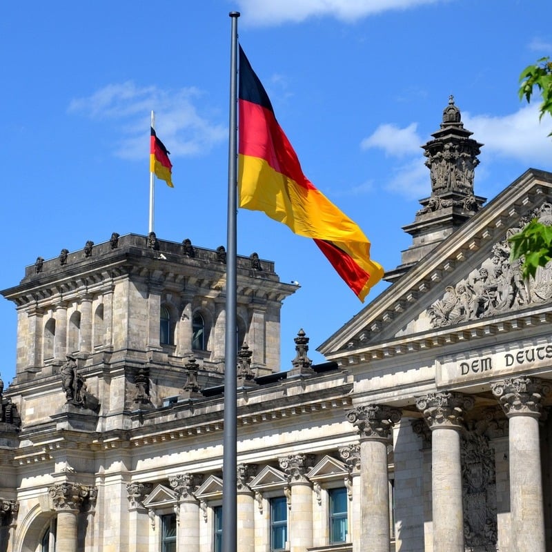 German Flag Flying In Front Of An Official Government Building In Berlin, Germany