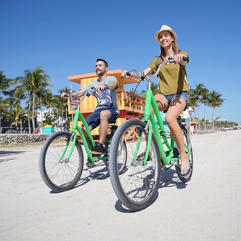 people on a beach with bikes