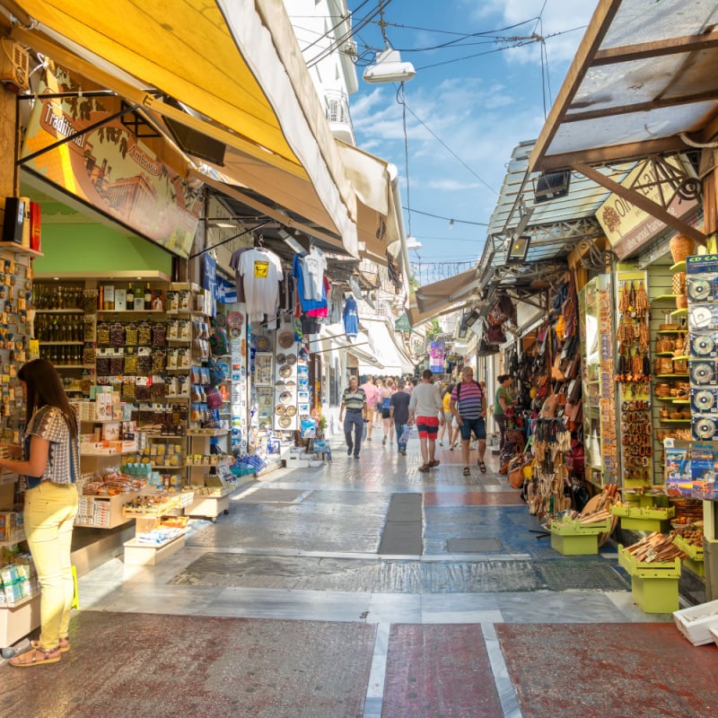 People shopping and buying souvenirs from markets at Plaka region of Athens, Greece.