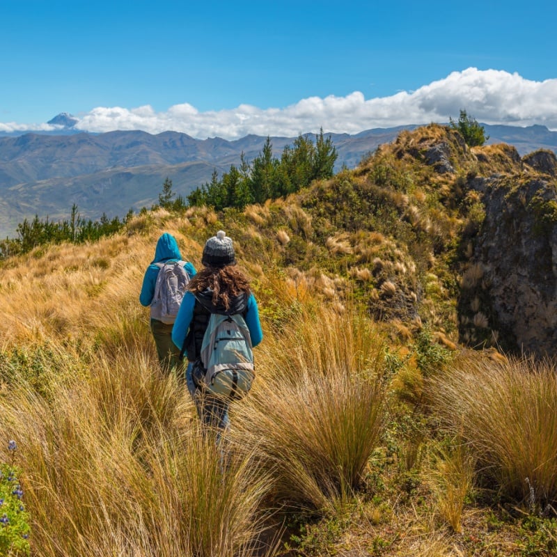 women walking along the famous Quilotoa Loop hike in the Andes mountains of Ecuador