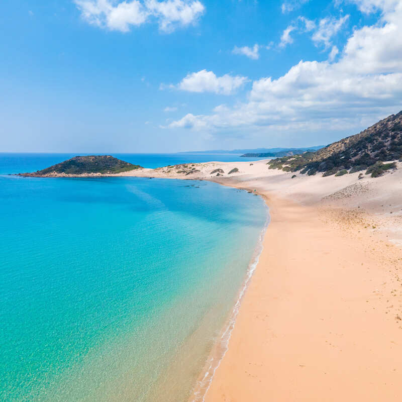 Golden Sand Beach Lapped By The Bright Blue Mediterranean Sea In Dipkarpaz, Northern Cyprus, Eastern Mediterranean