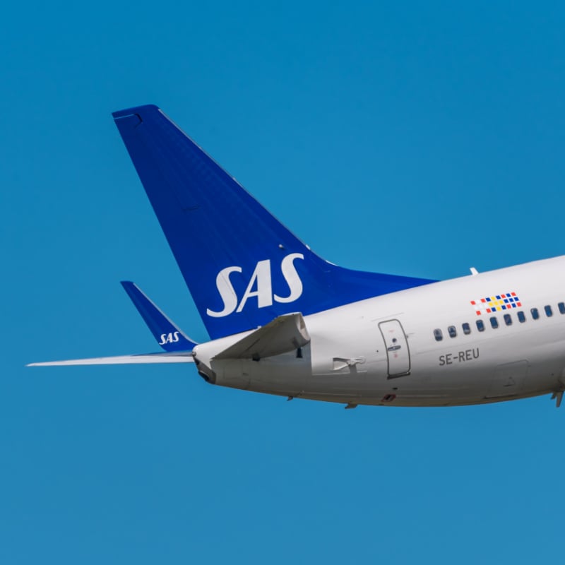 tail of a scandinavian airlines sas plane against a blue sky