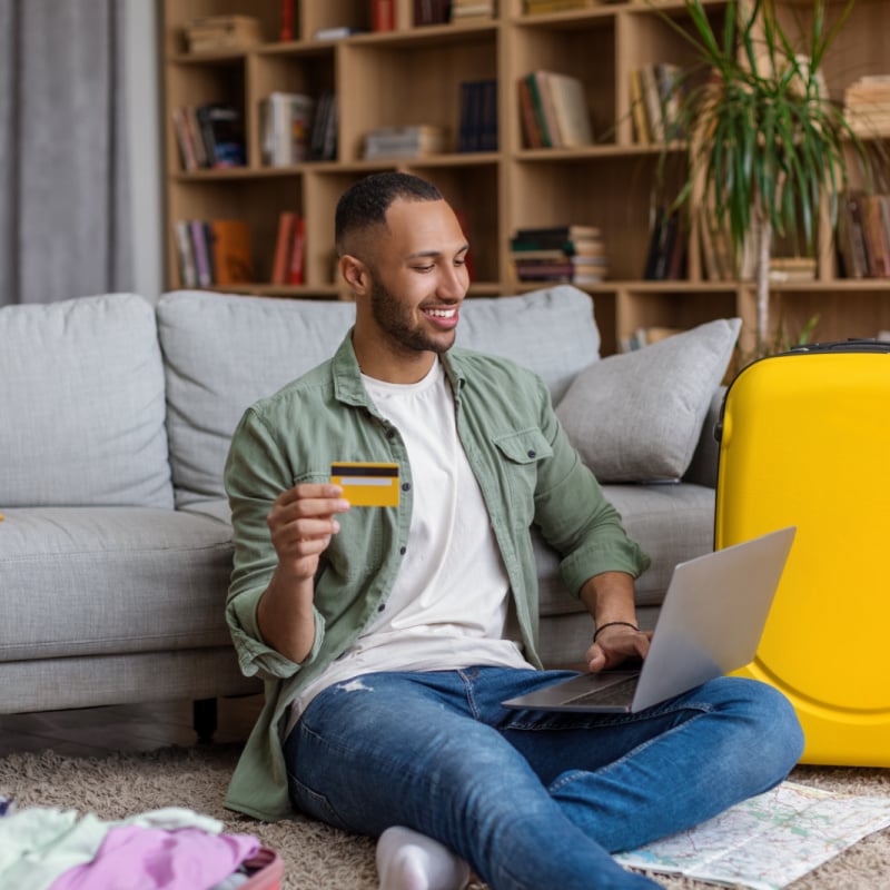 Man booking a flight at home