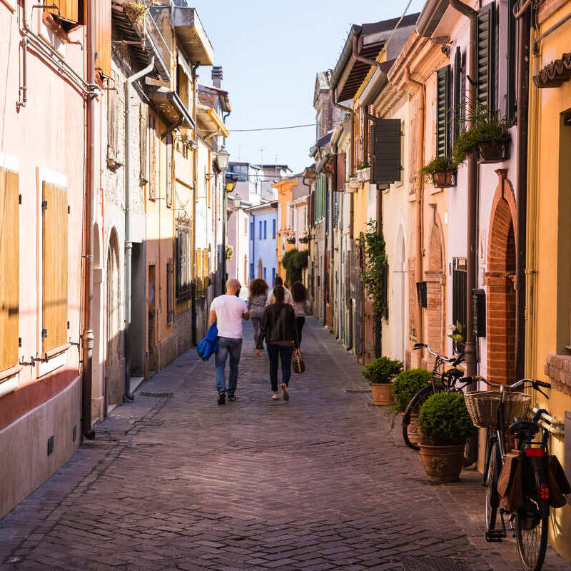 Tourists Walking A Narrow Street In Rimini, Italy, Southern Europe