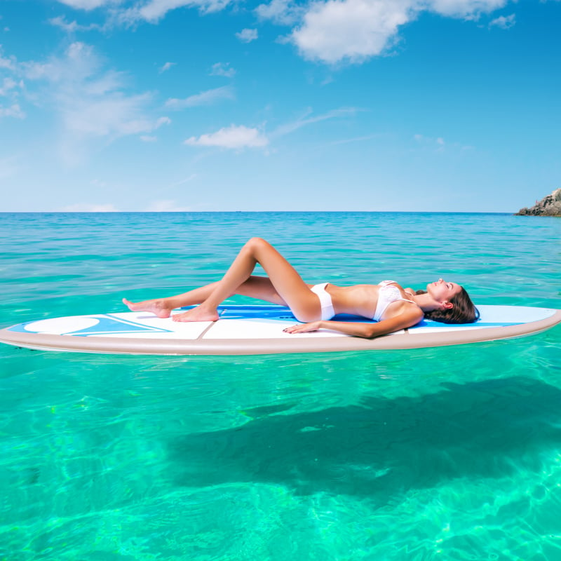 Woman Relaxing On A Paddleboard In Corsica, An Island In France, Mediterranean Europe