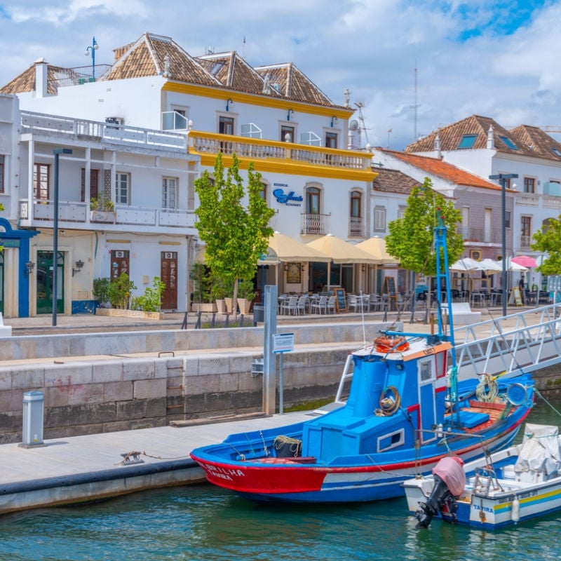 Boats and historic architecture in Tavira along canal