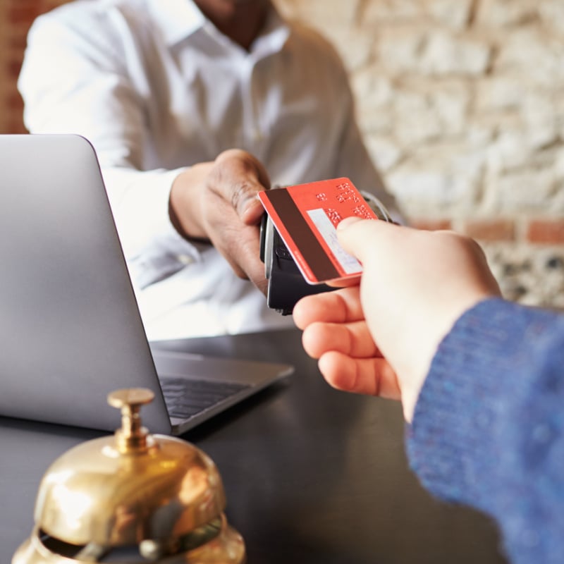 Guest making a card payment at a hotel check-in desk