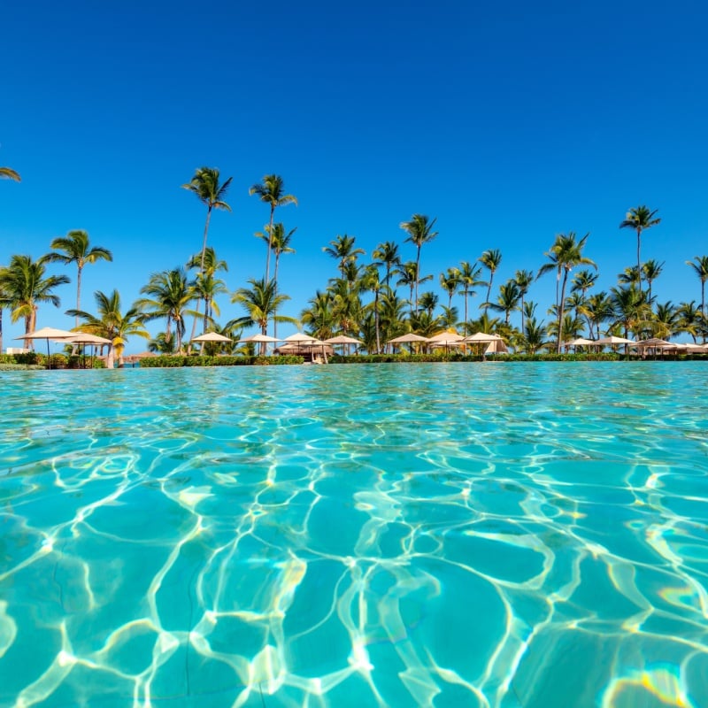 Swimming pool and palm trees in luxury resort at Punta Cana in the Dominican Republic