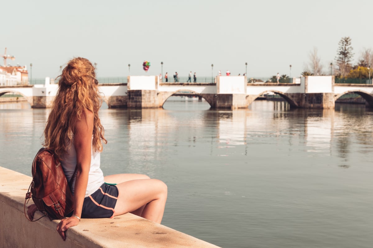 Female tourist visiting canal in Tavira