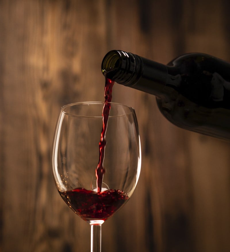 Wine being poured from a bottle to a glass