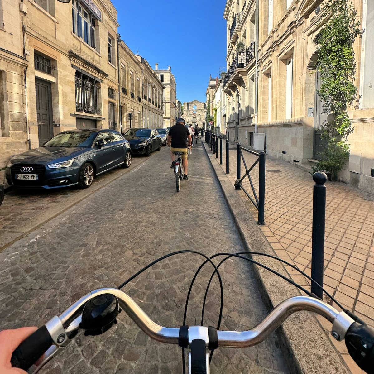 Managing Editor Tyler Fox riding a bike through Bordeaux on a bike tour of the city