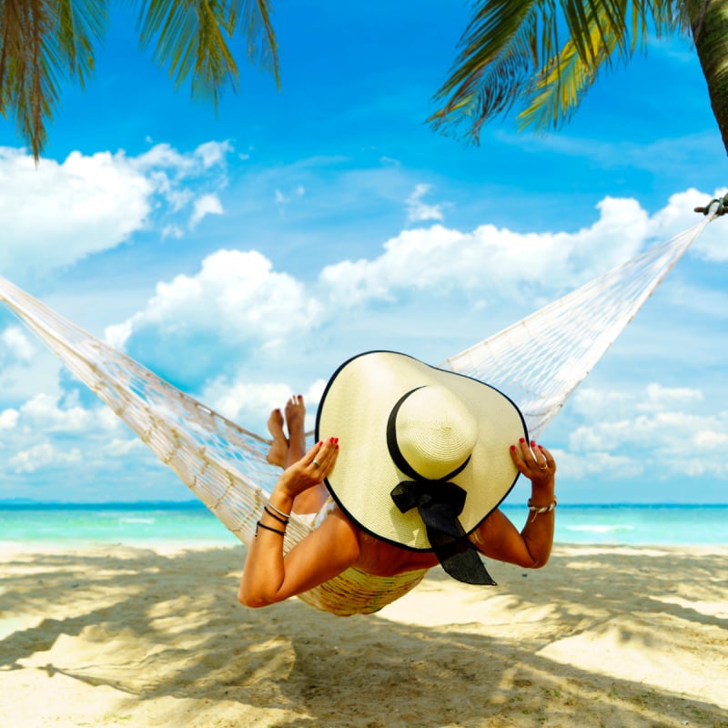 Woman relaxing on a hammock at the beach