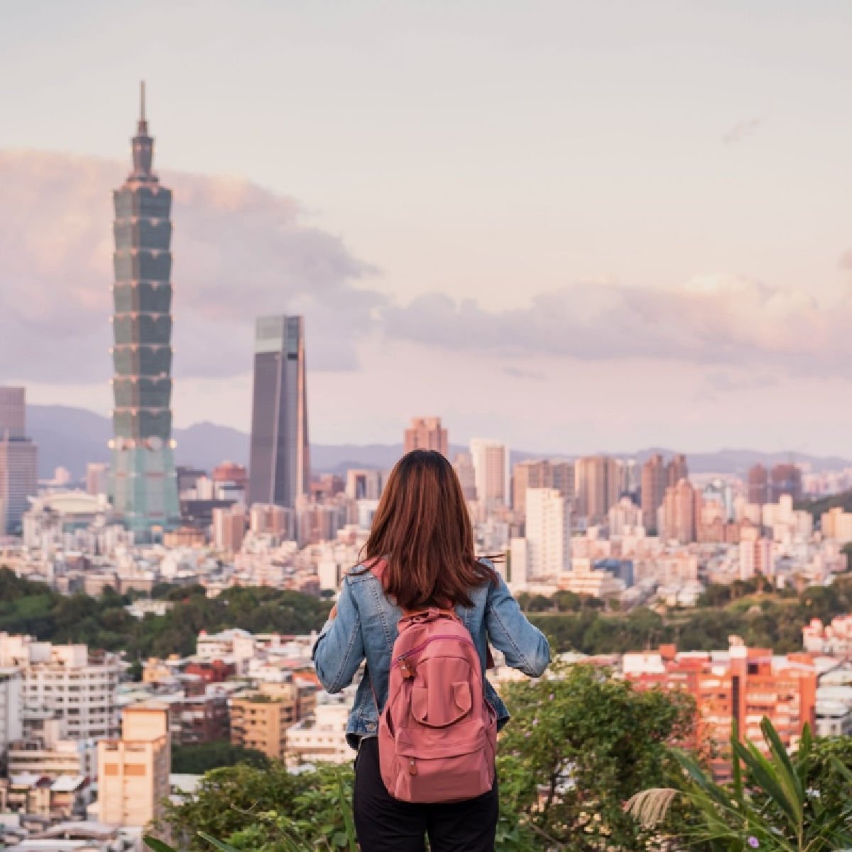 Woman overlooking skyline of Taipei