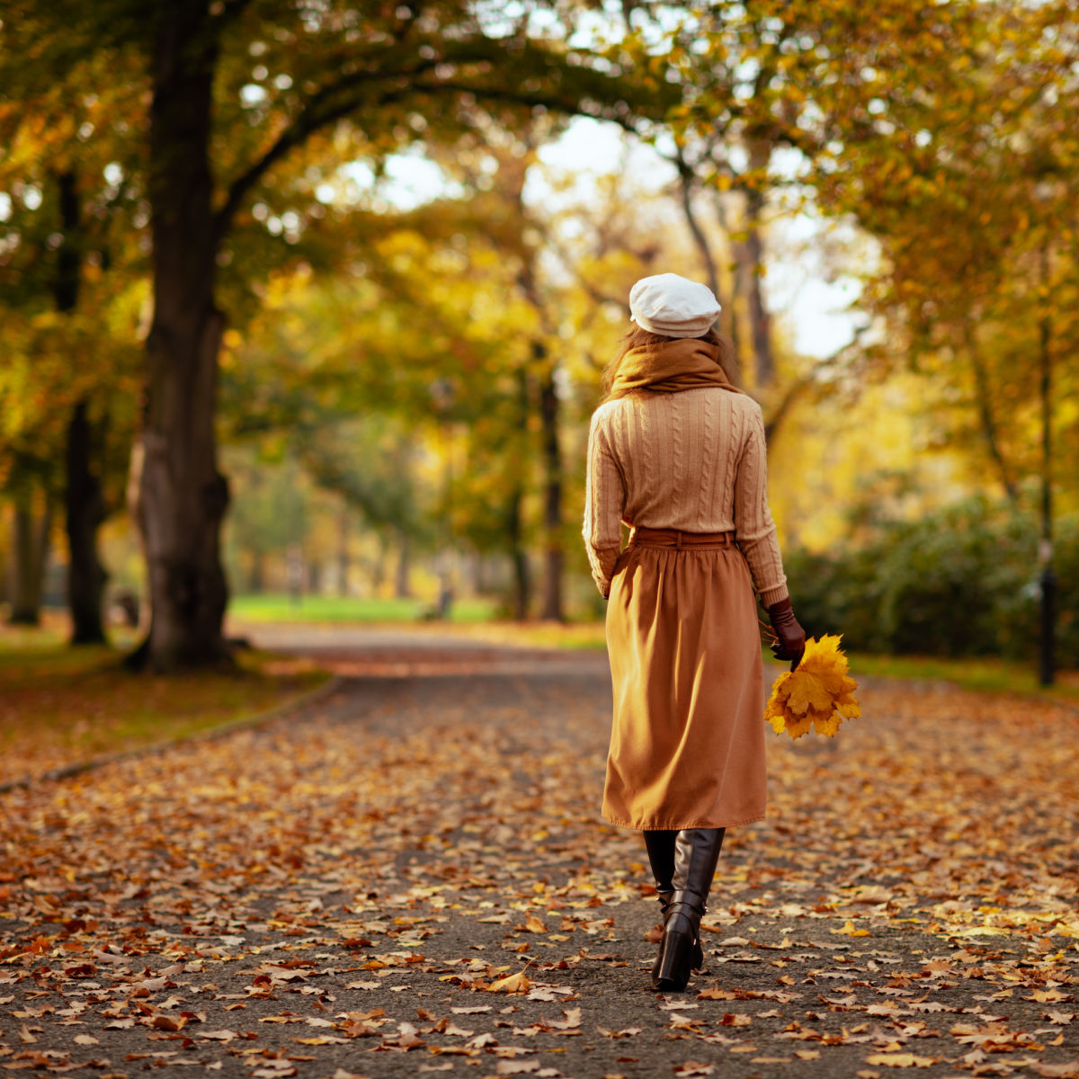 Woman walking through park in Jersey City in fall