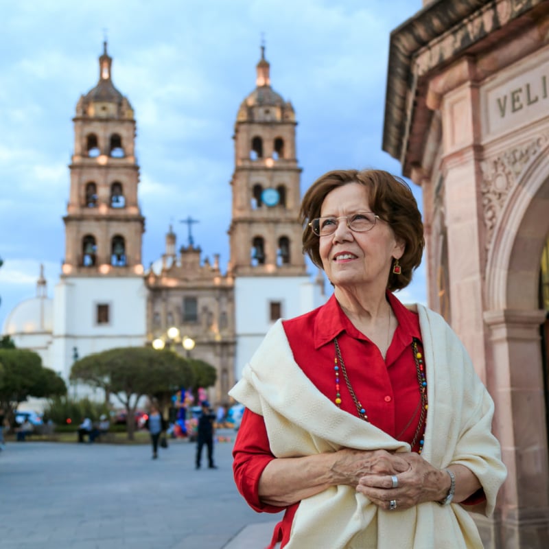 senior woman walking around the historic Cathedral square. Plaza de Armas, Durango, México