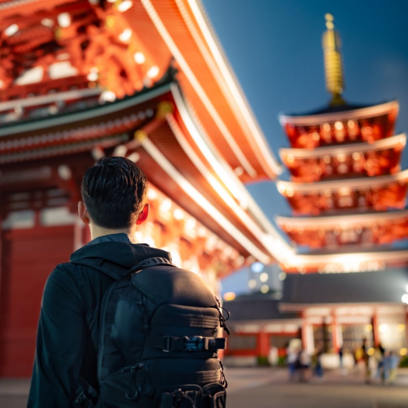 male solo traveler looks at pagodas in tokyo japan