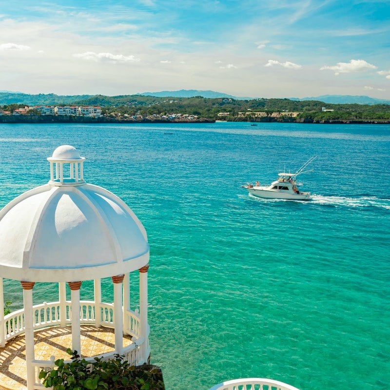 Beautiful White Gazebo And Tropical Flower Garden On Caribbean Ocean, Latin America