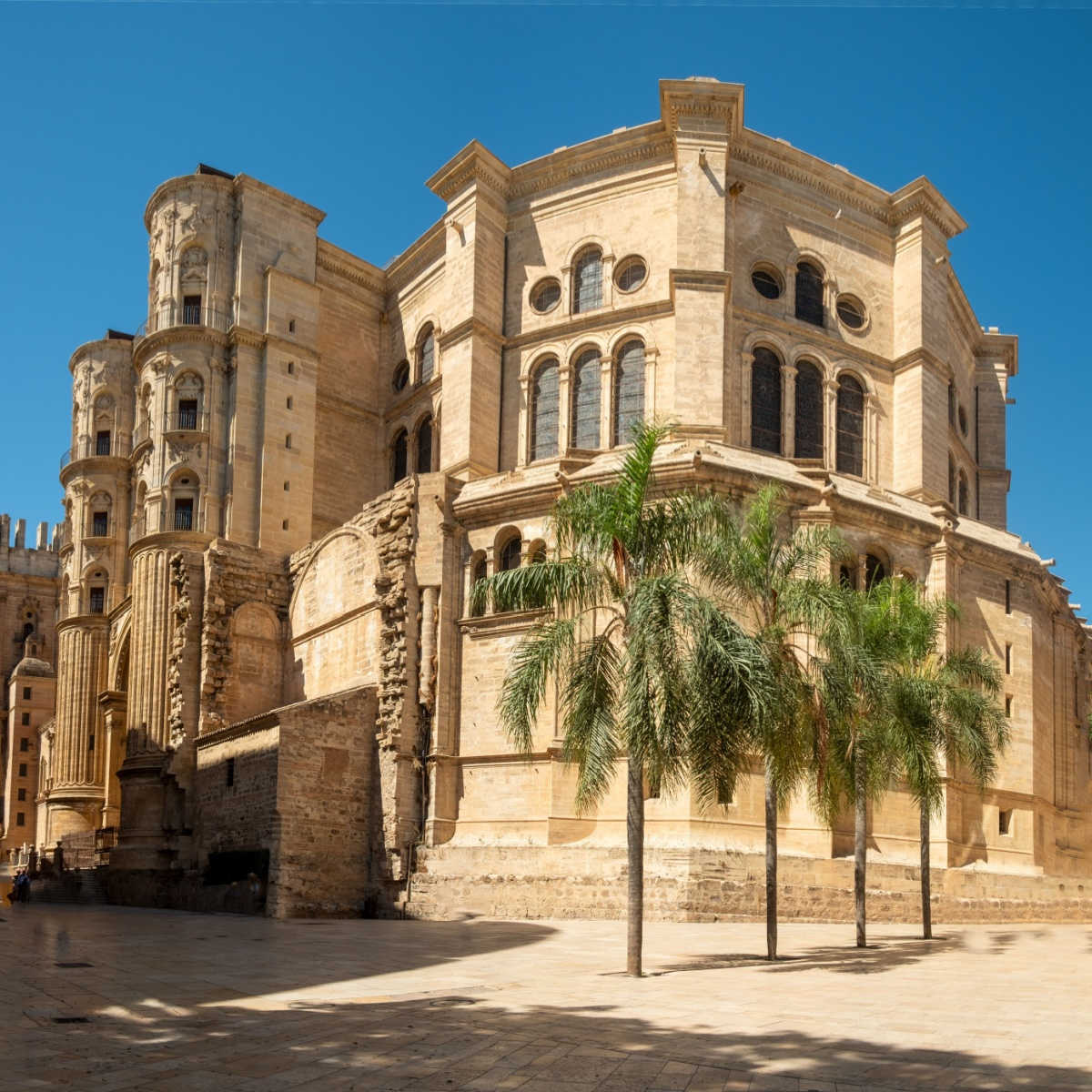 View of the Royal Monastery of San Jerónimo from Calle Compás de San Jerónimo on a sunny day with clear skies in Granada, Spain