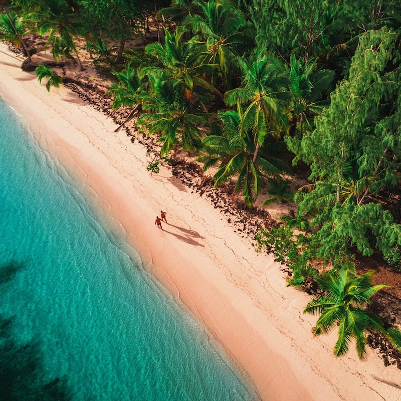 Couple Walking On A Beach In A Caribbean Destination