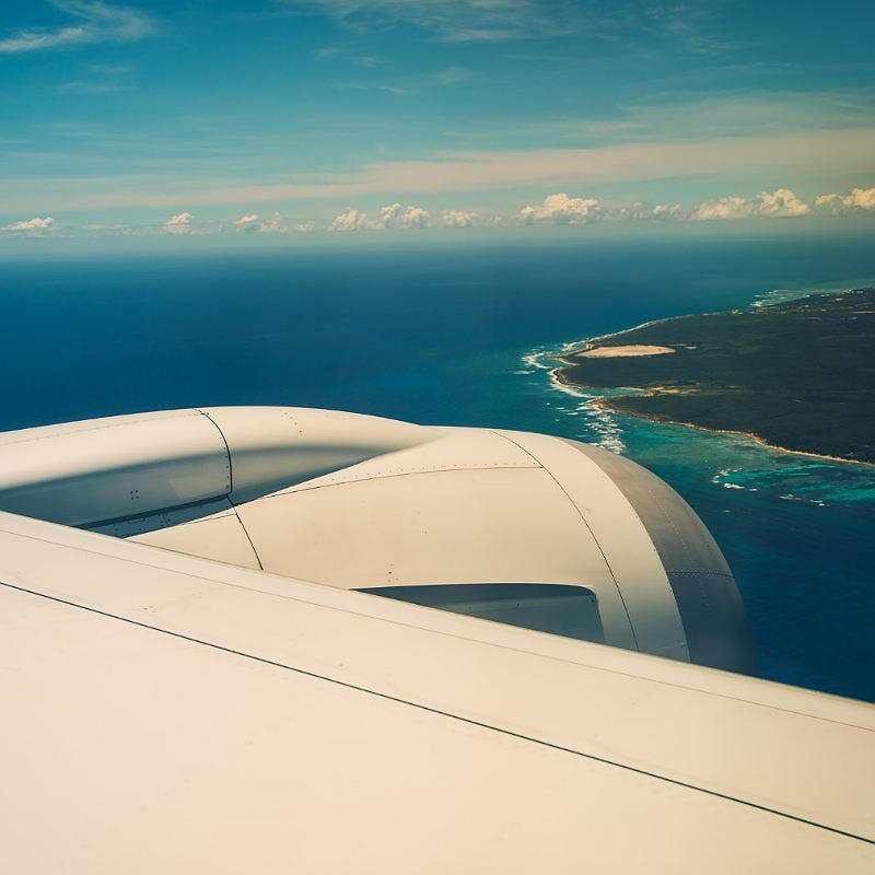 Aerial View Of A Plane Approaching A Caribbean Island