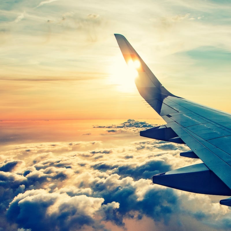 flying and traveling, view from airplane window on the wing on sunset time