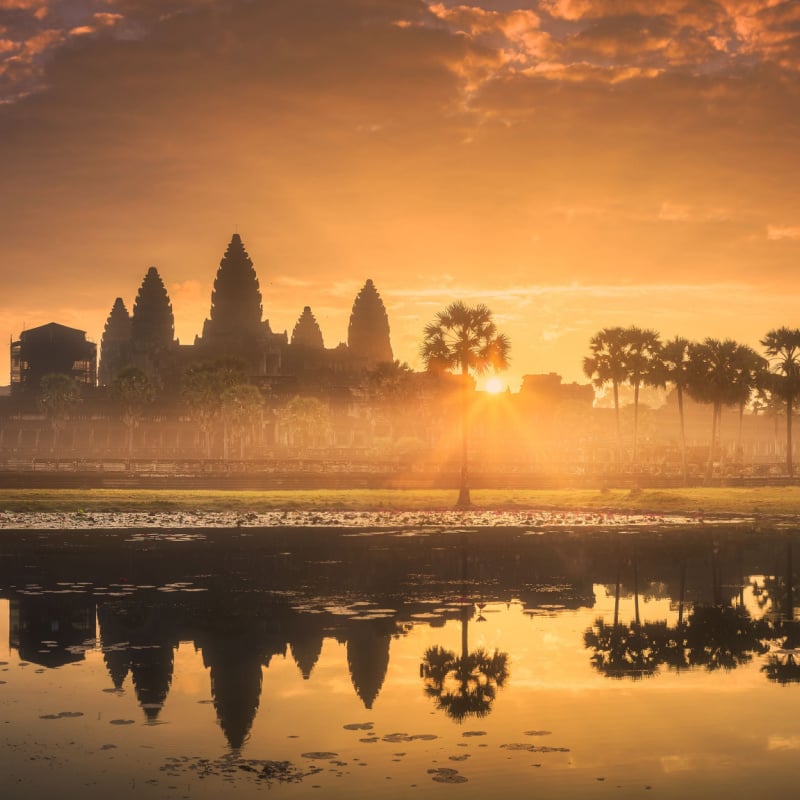 The golden sun rises above a temple in cambodia