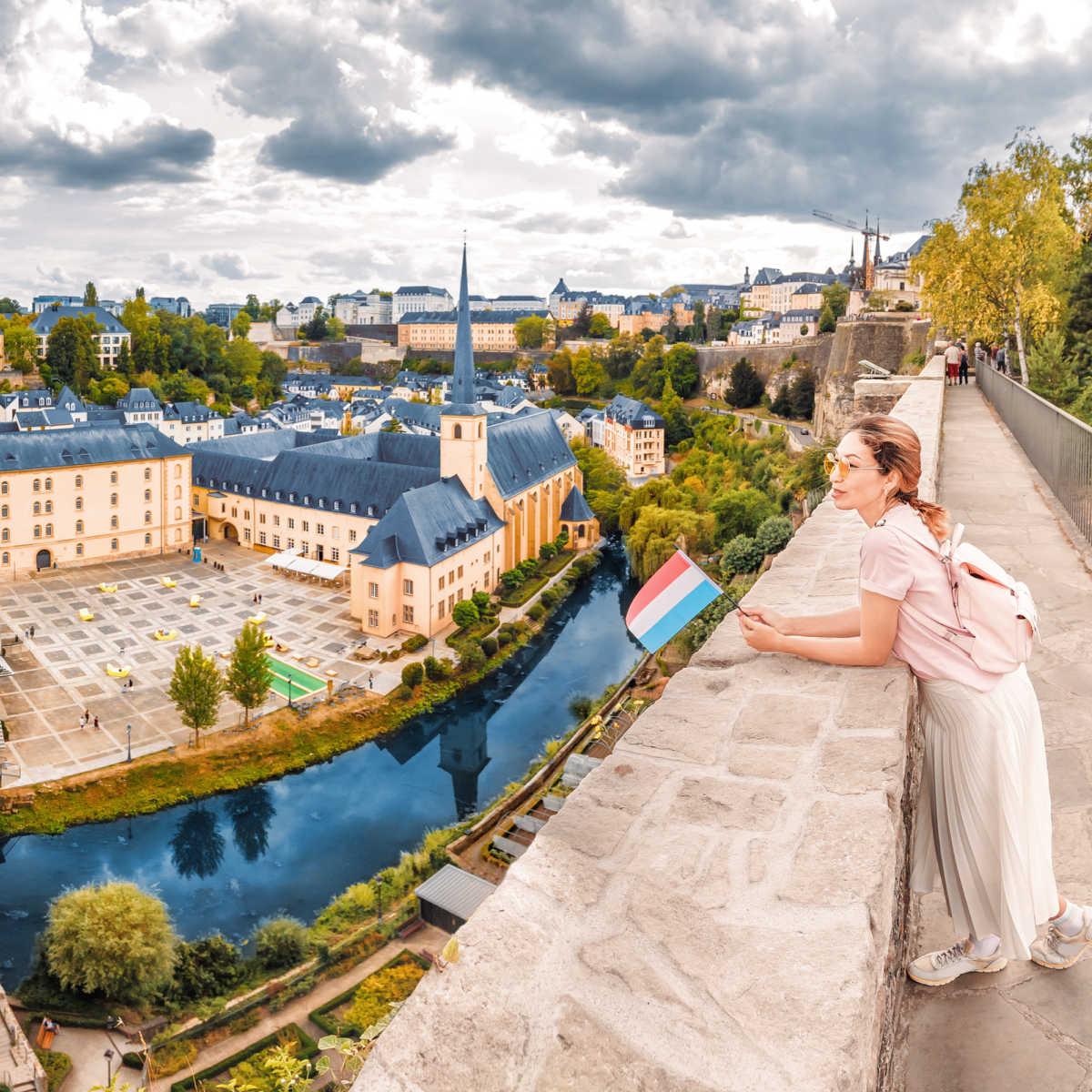 Tourist with Luxembourg flag overlooking cityscape