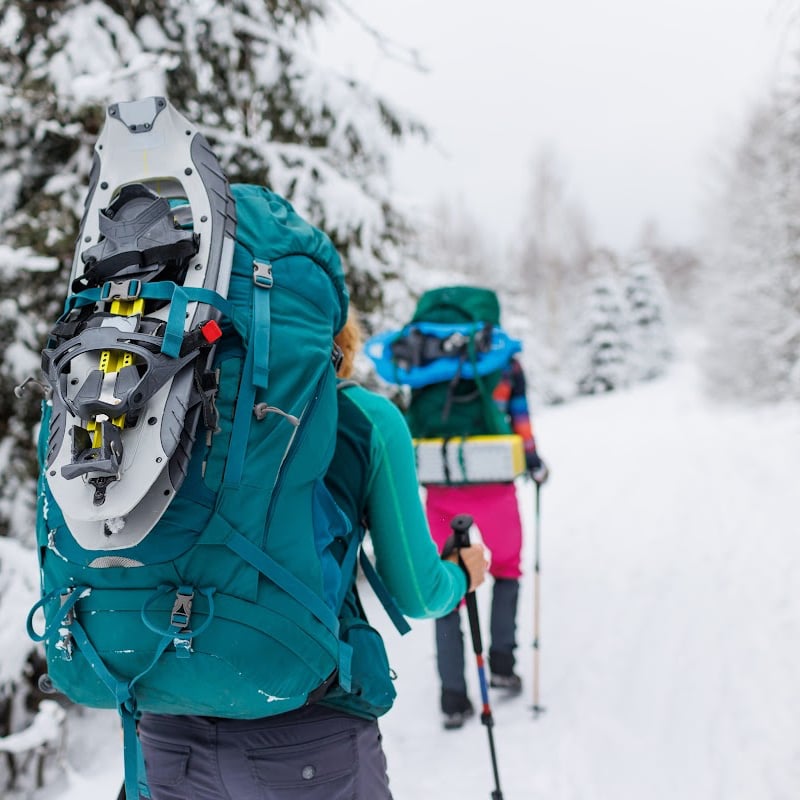 Two women walking in snowshoes