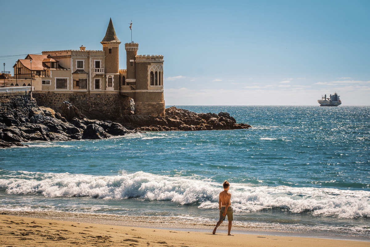 Young Boy On A Sandy Beach Facing Wulff Castle In Vina del Mar, Chile